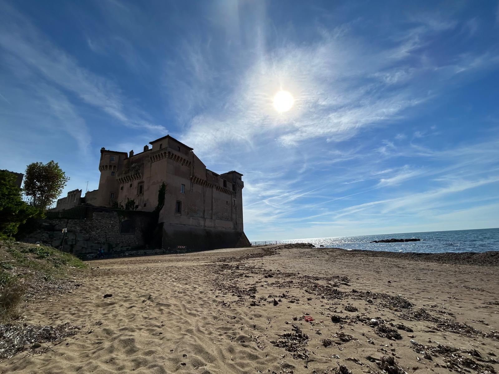 Santa Severa Castle overlooks the sea, combining a sandy beach, centuries of history, and Mediterranean scenery near Rome.